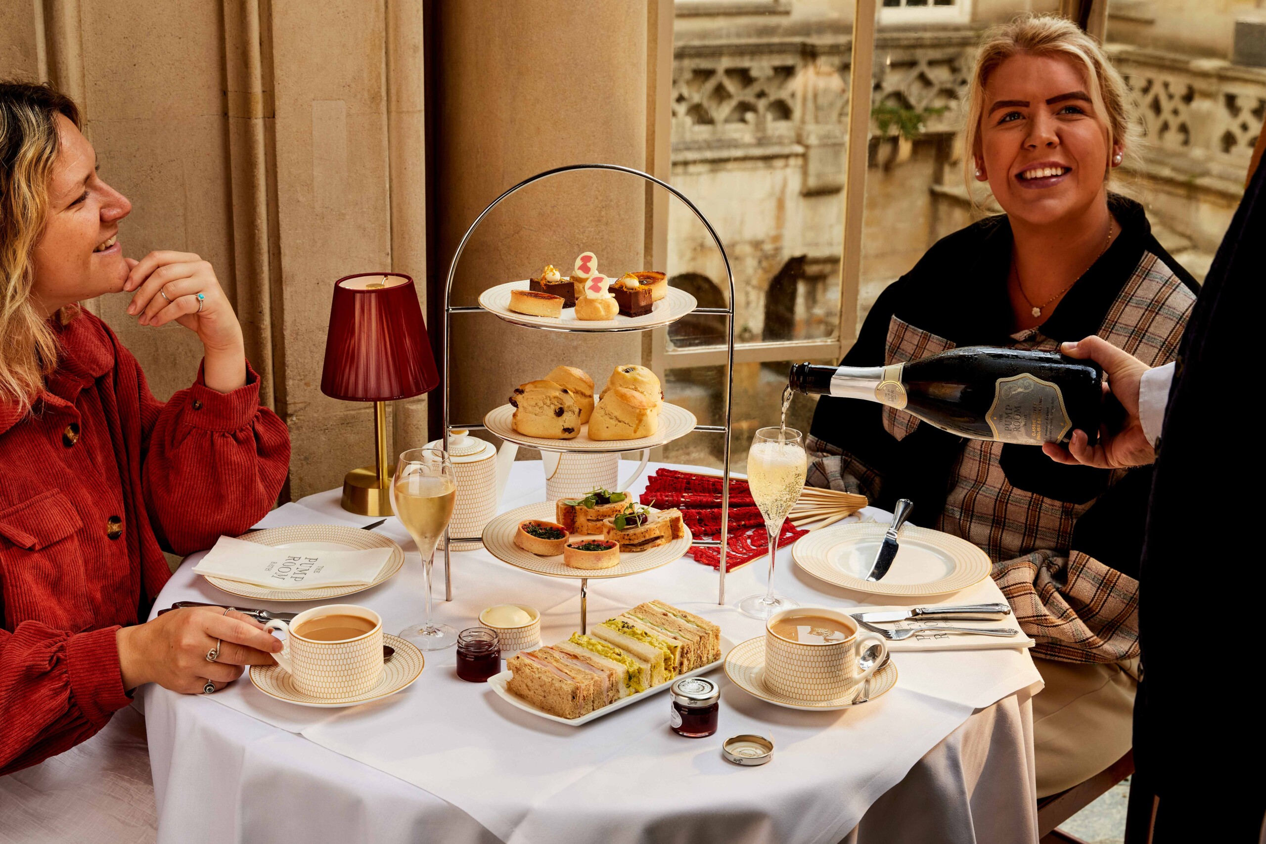 An autumnal afternoon tea served to two friends at the Pump Room, as Champagne is poured